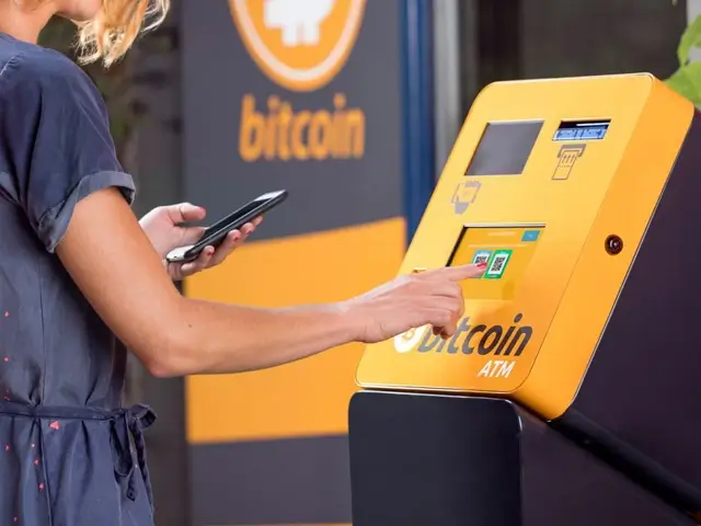 Woman using Bitcoin ATM